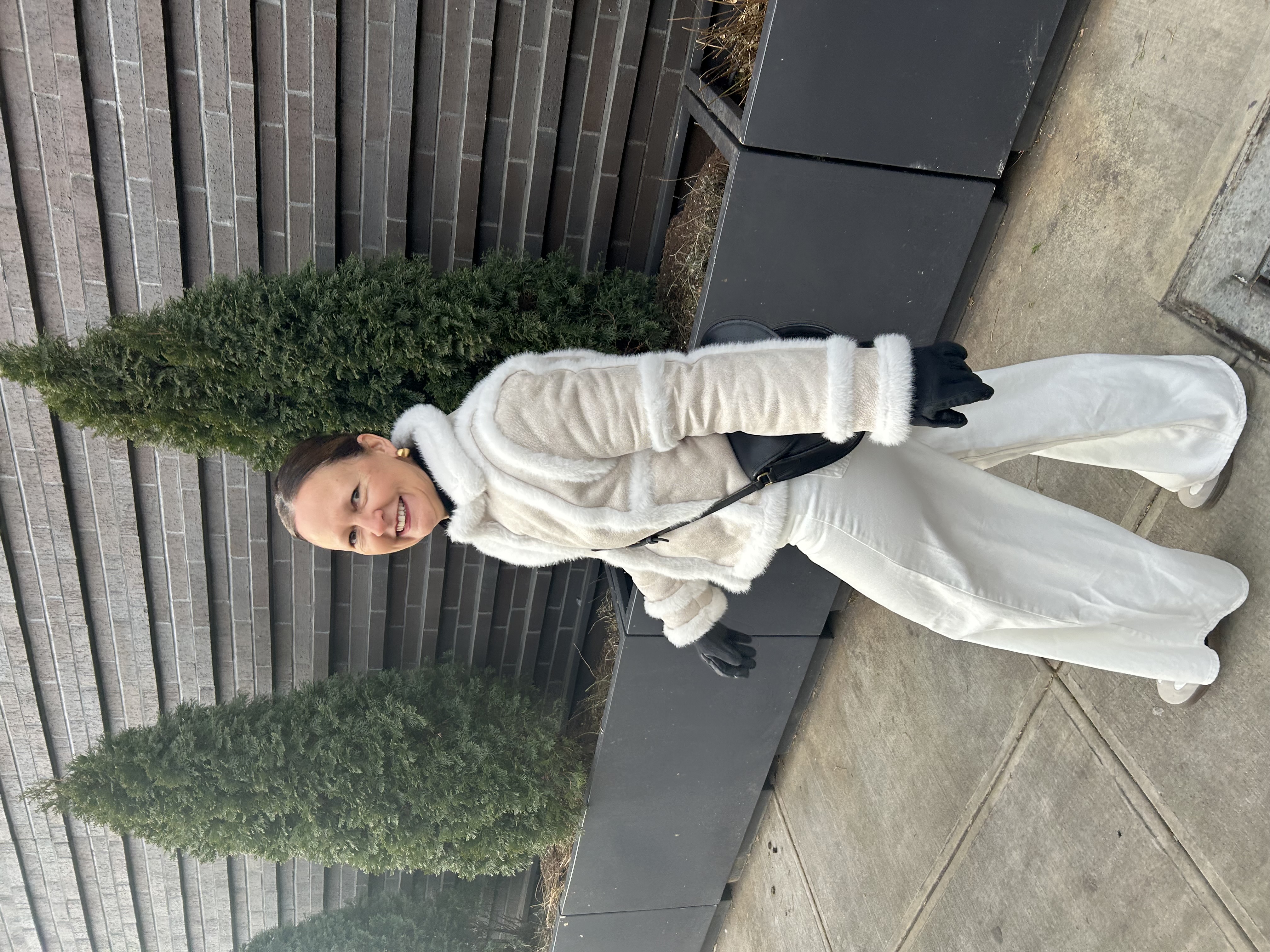 Pure Alignment founder smiling outdoors in white